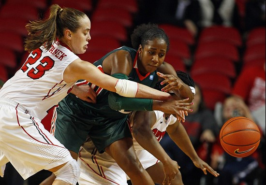 North Carolina State's Marissa Kastanek (23) battles for the ball with Miami's Shenise Johnson (42) during the second half. (AP Photo/Karl B DeBlaker)