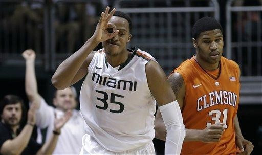 Miami's Kenny Kadji (35) celebrates after hitting a 3-point shot as he and Clemson' Devin Booker (31) run down court during the second half of a NCAA...