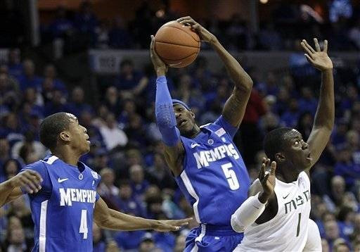 Memphis guards Will Barton (5) and Charles Carmouche (4) take a rebound away from Miami guard Durand Scott (1) during the first half of an NCAA...