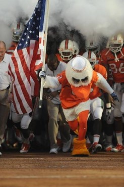 Sebastian the Ibis leads the University of Miami Hurricanes through a tunnel of smoke in a game against the Florida A&amp;M Rattlers at Sun Life...