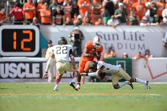 University of Miami Hurricanes running back Duke Johnson #8 carried the ball 30 times for 169 yards and scored two touchdowns in a game against the...