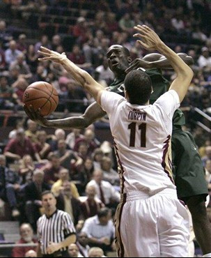Miami's Durand Scott looks for a shot against Florida State's Kiel Turpin during the first half of an NCAA college basketball game Wednesday, Feb. 13,...