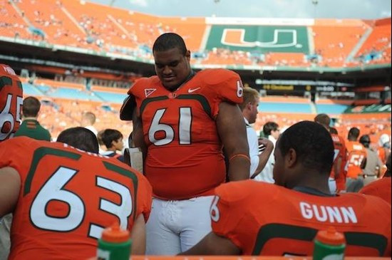 University of Miami Hurricanes offensive lineman Joel Fiqueroa #61 gets set to block in a game against the Virginia Cavaliers at Land Shark Stadium on...