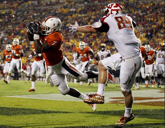Miami defensive back Vaughn Telemaque, left, picks off a pass attempt to Maryland tight end Matt Furstenburg in the end zone during the first half of...