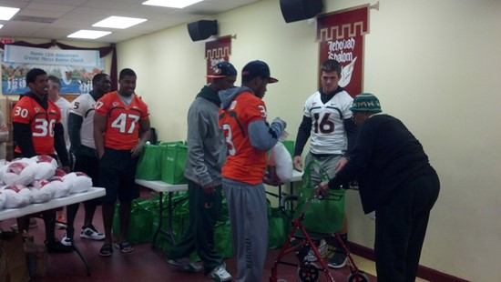 Seven football players and other staff delivered 48 turkey dinners to the Greater Mercy Missionary Baptist Church in Overtown.