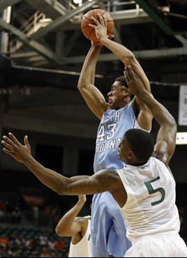 North Carolina's James Michael McAdoo (43) looks to pass as Miami's DeQuan Jones (5) defends during the first half of an NCAA college basketball game,...