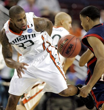 Jack McClinton and Saint Mary's forward Yusef Smith eye a loose ball. (AP Photo/Danny Johnston)