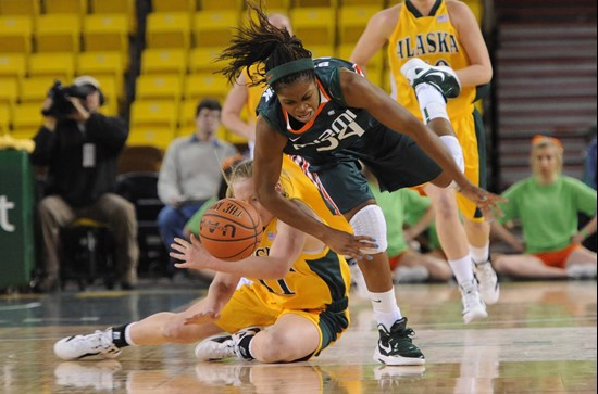 Miami's Sylvia Bullock, top, battles for a loose ball with Alaska Anchorage's Gritt Ryder. (AP Photo/Michael Dinneen)