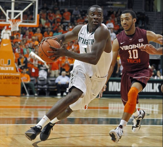 Miami's Durand Scott, left, drives past Virginia Tech's Marquis Rankin during the first half . (AP Photo/Miami Herald, Carl Juste)