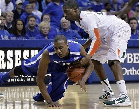 Miami guard Garrius Adams, top, fouls Memphis forward Wesley Witherspoon during the second half of an NCAA college basketball game in Memphis, Tenn.,...