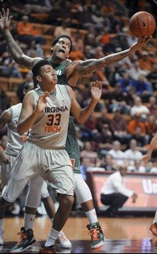 Miami's Julian Gamble, rear, grabs a rebound against Virginia Tech's Marshall Wood (33) during the first half of an NCAA college basketball game...
