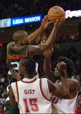Miami's Jack McClinton takes the ball to the basket as Maryland's James Gist (15) and Bambale Osby defend during the second half of a basketball game...