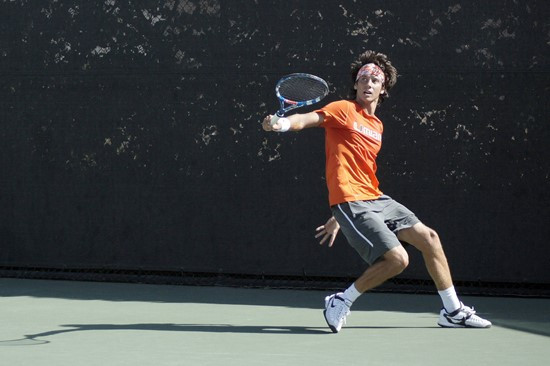 Junior Victor Mauz&acirc;&Acirc;&Acirc;?<sup>TM</sup> headband controls his hair as he delievers a backhand across the net.