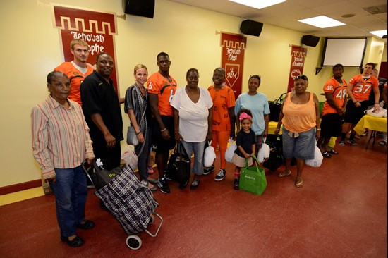 Players and coaches' wives took photos with several families Tuesday afternoon