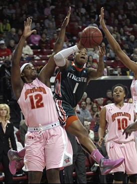 Miami guard Riquna Williams (1) goes up for a shot against Maryland center Lynetta Kizer (12) in the first half of an NCAA college basketball game in...