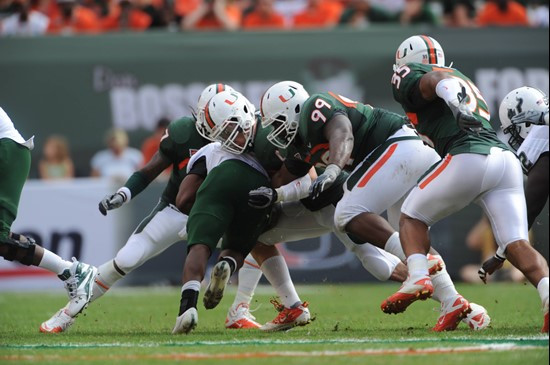University of Miami Hurricanes defensive lineman Marcus Forston #99 plays in a game against the University of South Florida Bulls at Sun Life Stadium...