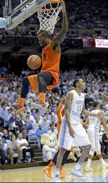 Miami's Erik Swoope dunks as North Carolina's Brice Johnson (11) looks away during the second half of an NCAA college basketball game in Chapel Hill,...