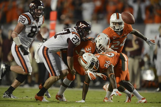 University of Miami Hurricanes defensive back Antonio Crawford #39 and Herb Waters #86 scramble to recover the ball after a blocked punt in a game...