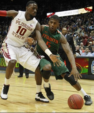Miami guard/forward DeQuan Jones (5) works against Florida State forward Okaro White (10) during the first half of an NCAA college basketball game in...