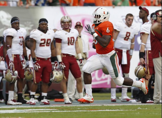 Miami's Lamar Miller runs for a first quarter touchdown against Boston College during an NCAA college football game, Friday, Nov. 25, 2011 in Miami....