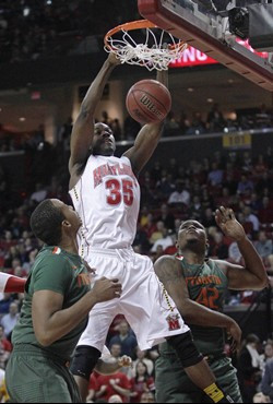 Maryland forward James Padgett (35) dunks on Miami's Kenny Kadji, left, and Reggie Johnson in the first half of an NCAA college basketball game in...