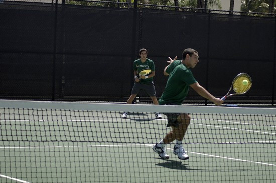 Sophomore Diego Soto watches as teammate Gabriel Flores returns a short shot.