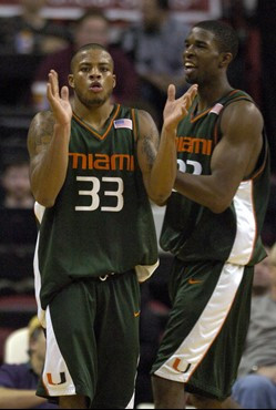Miami's Jack McClinton, (33), and Brian Asbury celebrate their victory over Maryland as time runs out of their basketball game Wednesday, Jan. 10,...
