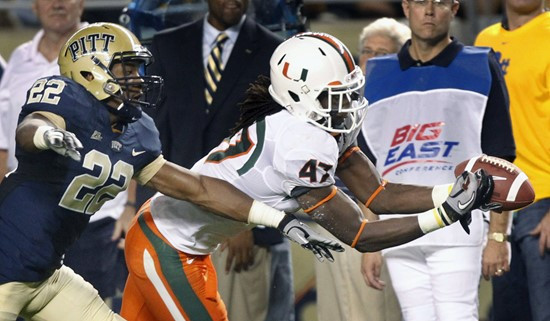 Miami (Fl) wide receiver LaRon Byrd (47) catches a pass for a first down in front of Pittsburgh cornerback Antwuan Reed (22) in the second quarter of...