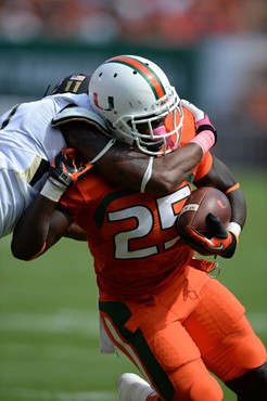 University of Miami Hurricanes running back Dallas Crawford #25 carries the ball in a game against the Wake Forest Demon Deacons at Sun Life Stadium...