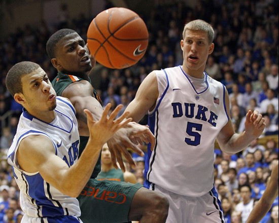 Duke's Seth Curry, left, and Mason Plumlee (5) struggle for a rebound against Miami's DeQuan Jones during the second half  of an NCAA college...