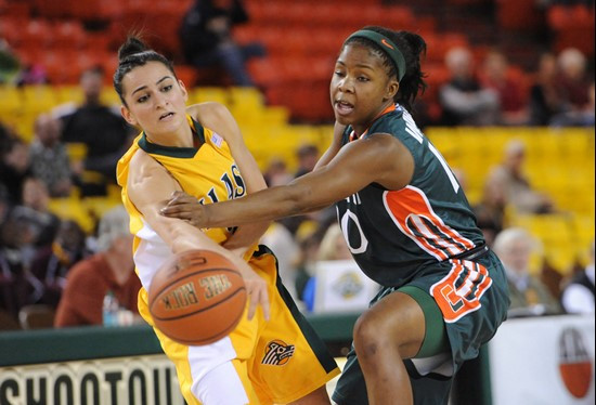 Miami's Michelle Woods, at right, defends against Alaska Anchorage's Bruna Deichmann. (AP Photo/Michael Dinneen)