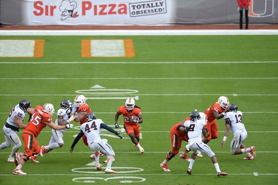 University of Miami Hurricanes running back Dallas Crawford #25 plays in a game against the Virginia Cavaliers at Sun Life Stadium on November 23,...