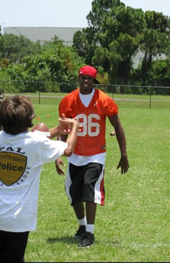 Tommy Streeter plays catch with a youngster at the Ezell Hester Community Center