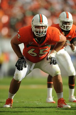 University of Miami Hurricanes offensive lineman Hunter Wells #64 gets set to block in a game against the Duke Blue Devils at Sun Life Stadium on...