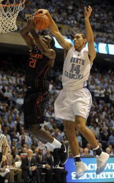 North Carolina's Danny Green (14) blocks Miami's Dwayne Collins (21) in the first half. (AP Photo/Sara D. Davis)