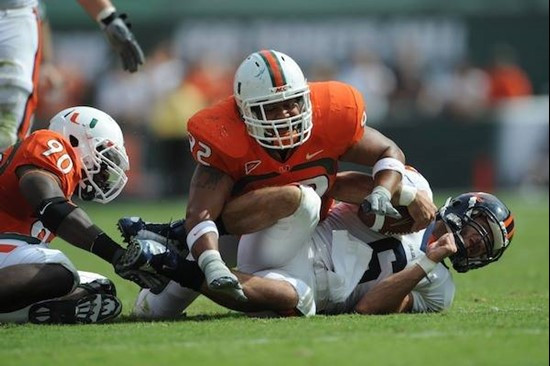 University of Miami Hurricanes defensive lineman Josh Holmes #92 gets a sack in a game against the Virginia Cavaliers at Land Shark Stadium on...