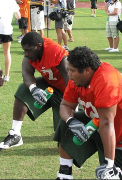 Defensive linemen Allen Bailey (l) and Josh Holmes (r) at UM's first practice of the 2009 fall season.