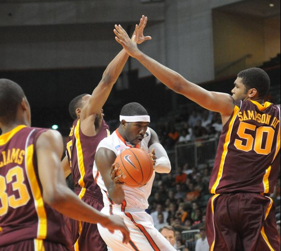 Malcolm Grant is guarded by Minnesota's Al Nolen and Ralph Sampson, right. (AP Photo/Miami Herald, Peter Andrew Bosch)