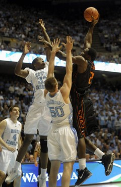 Miami's Dwayne Collins, right, shoots over North Carolina's Tyler Hansbrough (50) and Ed Davis (32) in the first half. (AP Photo/Sara D. Davis)
