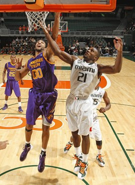CORAL GABLES, FL - NOVEMBER 11: Erik Swoope #21 of the Miami Hurricanes goes to the basket while being defended by Liam McMorrow #00 of the Tennessee...