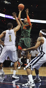 Miami guard Rion Brown shoots between Georgia Tech forward Julian Royal (1) and guard Pierre Jordan. (AP Photo/Gregory Smith)