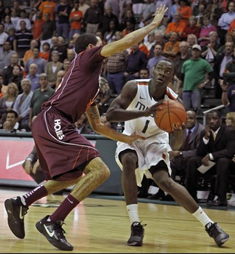 Miami's Durand Scott, right, sets for his drive while being covered by Virginia Tech's Erick Green. (AP Photo/Miami Herald, Carl Juste)