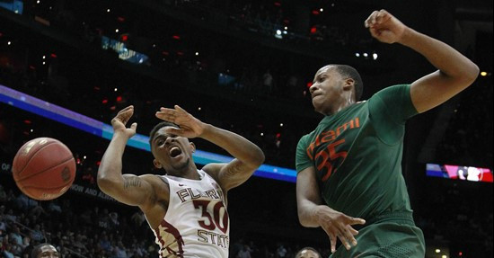 Miami forward/center Kenny Kadji (35) defends against Florida State guard Ian Miller (30) during the first half of an NCAA college basketball game in...