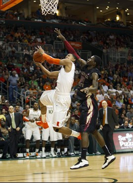 Florida State's Okaro White (10) is unable to block Miami's Rion Brown (15) during the second half of an NCAA college basketball game in Coral Gables,...