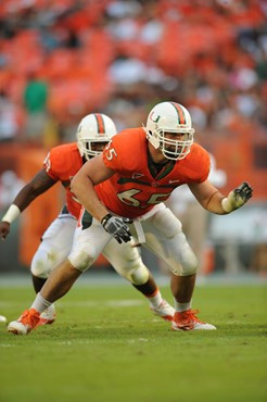 University of Miami Hurricanes offensive lineman Brandon Linder #65 gets set to block in a game against the Duke Blue Devils at Sun Life Stadium on...