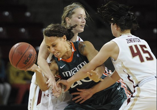 Miami's Shawnice Wilson (40) loses control of the ball under pressure from Boston College's Kerri Shields, rear, and Katie Zenevitch (45). (AP...