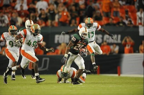University of Miami Hurricanes running back Damien Berry #20 breaks tackles and makes a long run in a game against the Florida A&M Rattlers at Land...