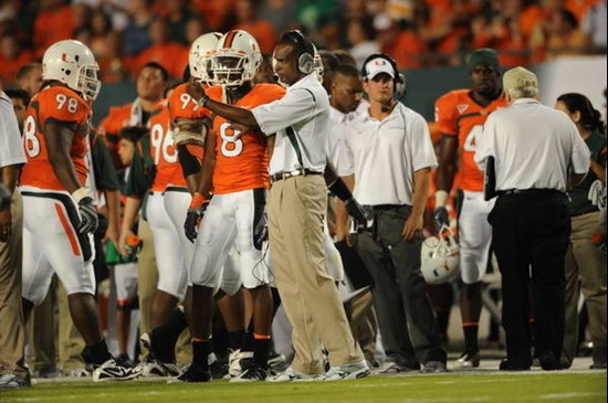 University of Miami Hurricanes head coach Randy Shannon gives some last minute instructions to defensive back DeMarcus Van Dyke #8 in a game against...