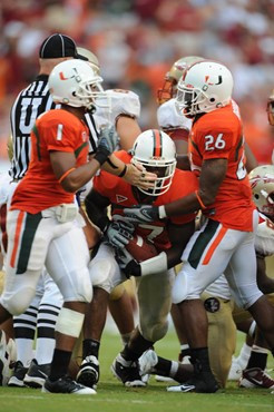 University of Miami Hurricanes RE Adewale Ojomo #97 recovers a fumble at the start of the third quarter in a game against The Florida State Seminoles...