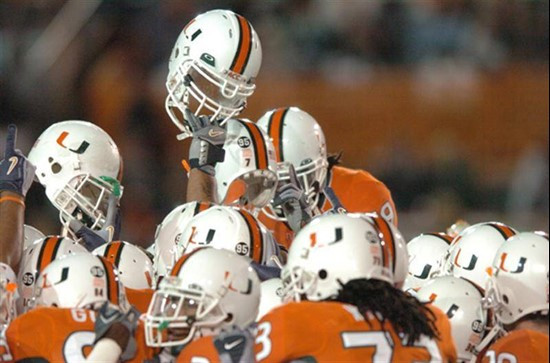 University of Miami players raise their helmets in a sign of unity before a game against Boston College. The Hurricanes and Boston College players...